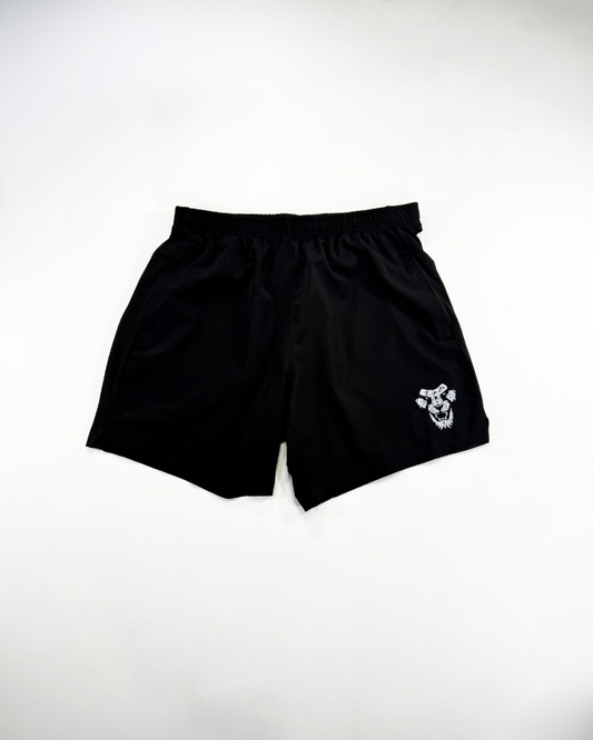 Black shorts with a small white logo on a light gray background