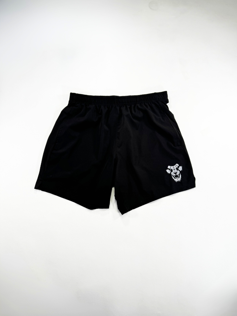 Black shorts with a small white logo on a light gray background